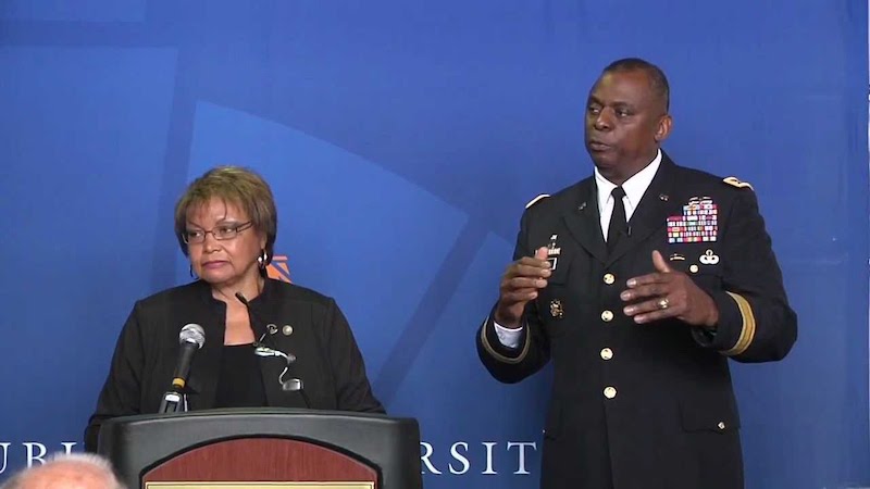 this is a photo of Auburn University alumnus General Lloyd Austin, the first black secretary of defense, with his wife Charlene speaking at an Auburn event