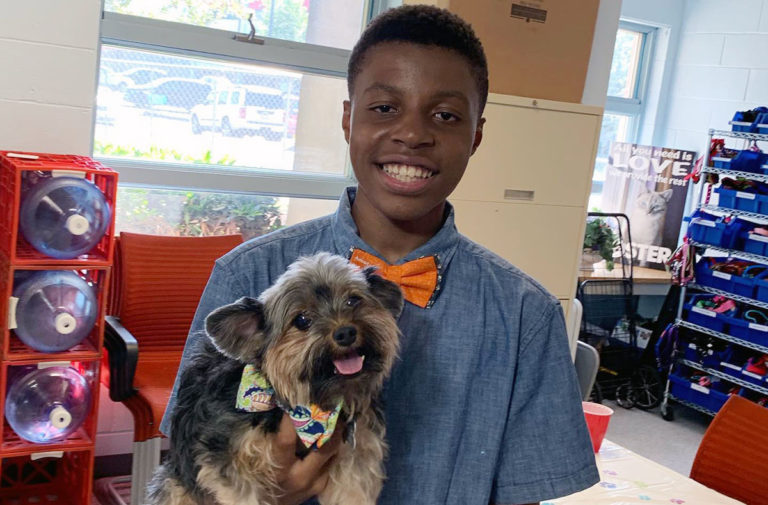 this photo shows Darius Brown with a dog wearing one of his bowties
