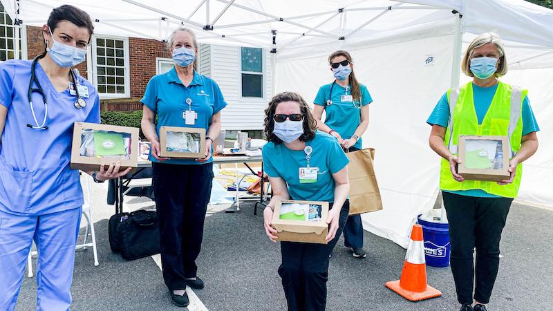 this photo shows a group of women from Davidson College in masks for Feed the Front Line