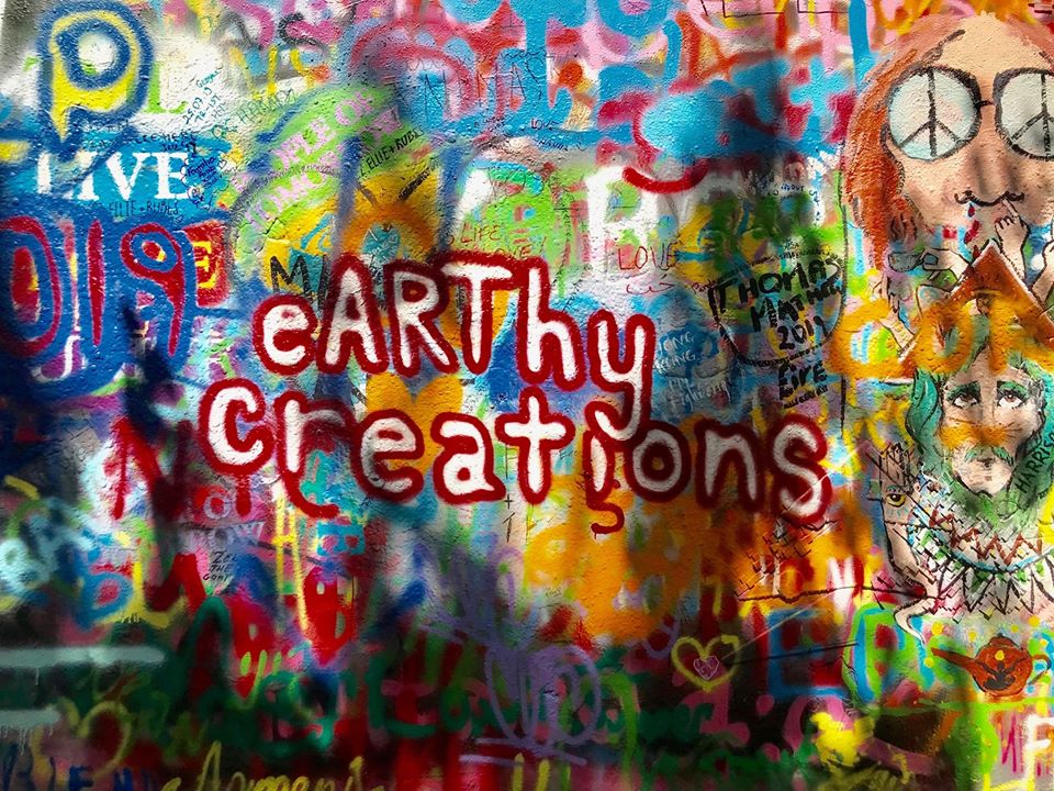 this photo shows the eyecatching earthy creations logo at the John Lennon Wall