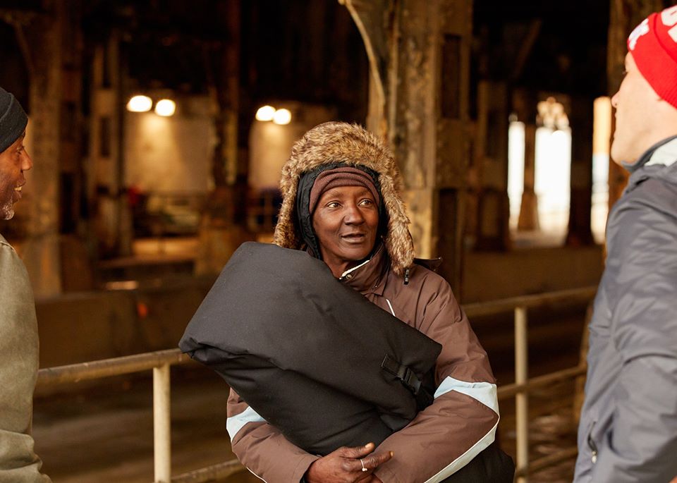 this photo shows a homeless woman with a coat from Empowerment Plan