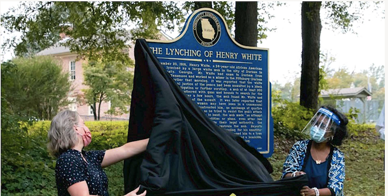 this is a photo of two women unveiling the Henry White Memorial marker in Lafayette, Georgia