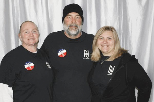 photo of jennifer langston of Reboot Jackson with colleagues in black logoed shirts