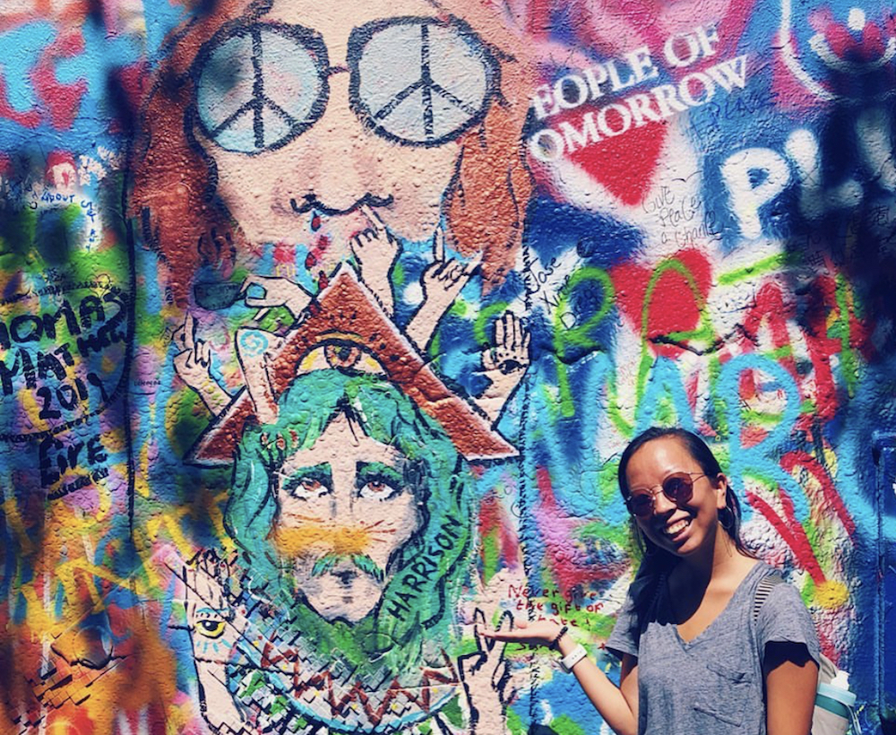 this photo shows the subject's excitement to visit the John Lennon Wall in Prague