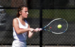 this is a photo of Algernon Sydney Sullivan Award recipient Lucy Burch playing tennis for Huntingdon College