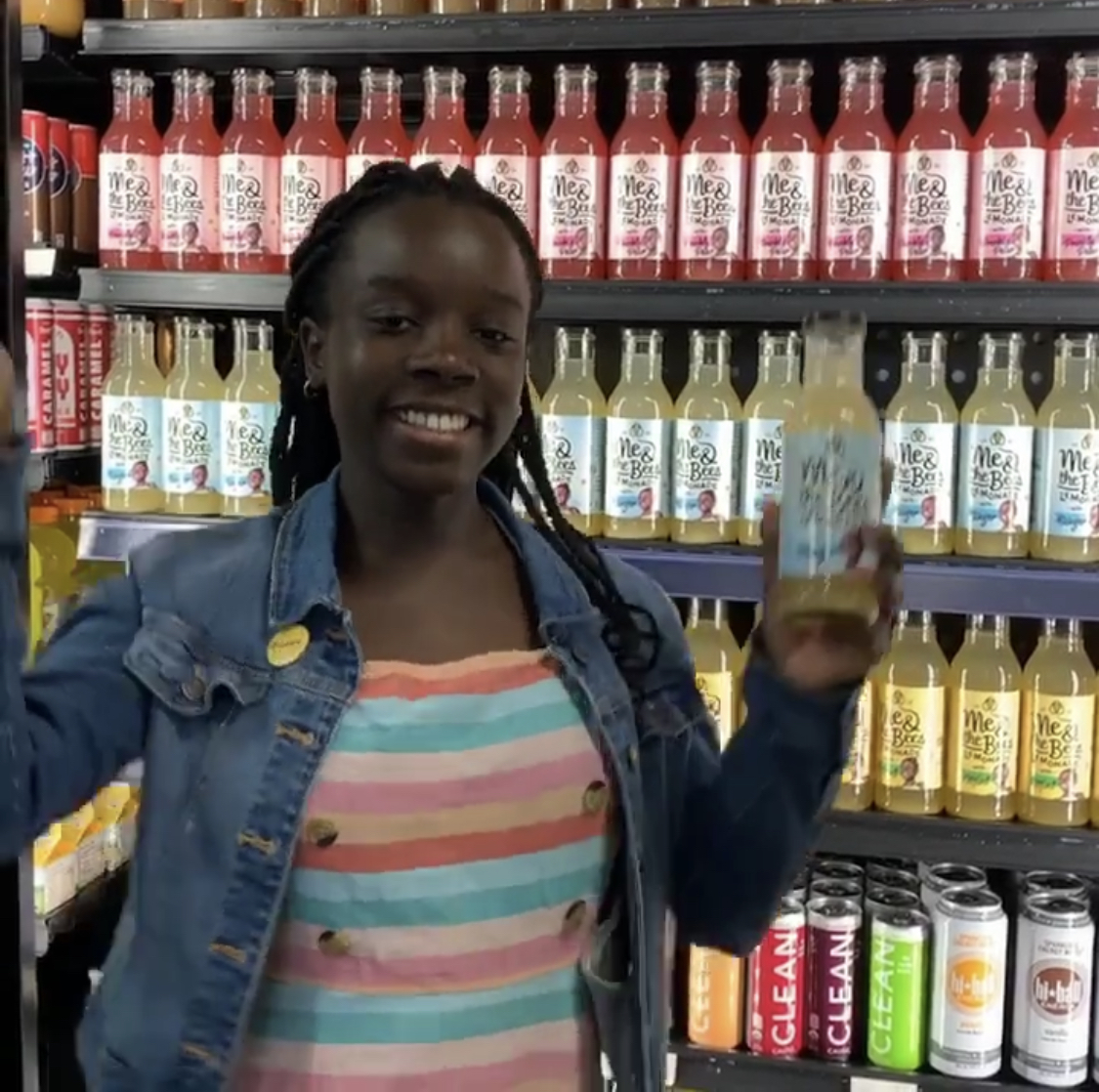 this photo shows Mikaila Ulmer with her Me & the Bees Lemonade bottles on supermarket shelves
