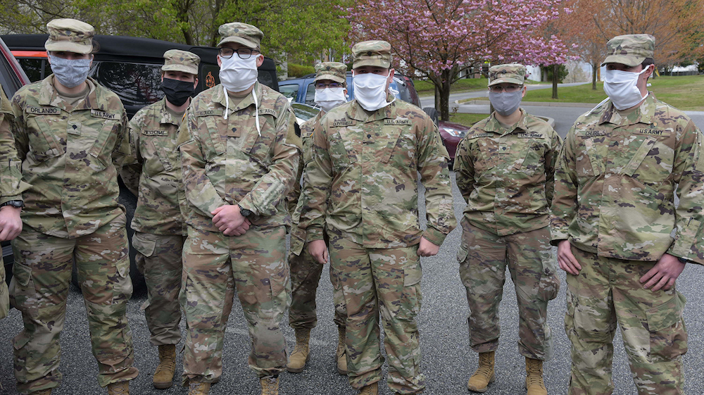 this photo shows Victoria Orlando and her fellow National Guard members in uniforms and masks