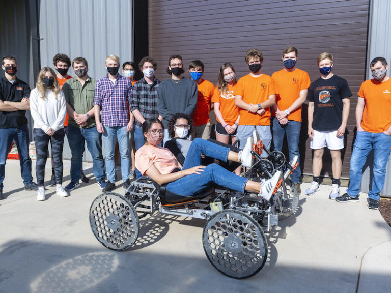 this photo shows Campbell University students in a rover they designed for space missions for a NASA competition.
