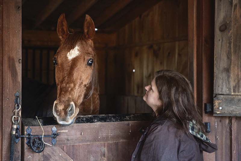 In this picture Sarah Barwick visits with a rescue horse named Mia at Feel Good Farm