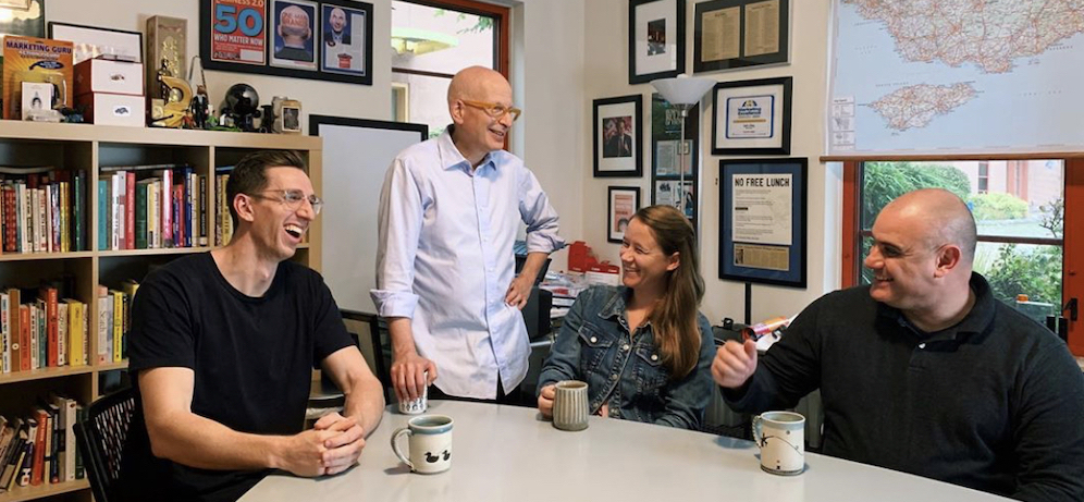 Seth Grodin, founder of Akimbo, is shown in an office with members of his altMBA team