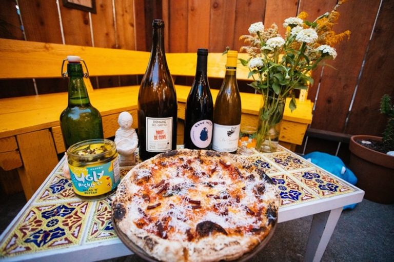 this photo shows a pizza made with food waste ingredients from Shuggie's Trash Pies and Natural Wine, a sustainable restaurant opening this spring in San Francisco