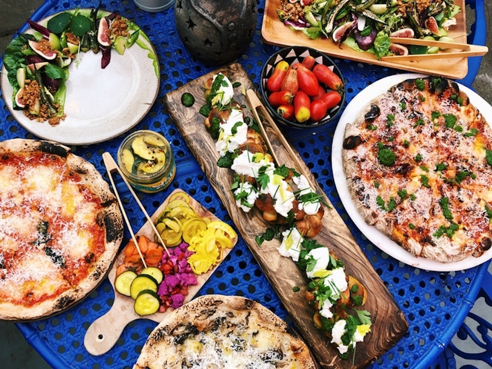 this photo shows a variety of colorful dishes, made with food waste and surplus vegetables, to be offered at Shuggie's Trash Pies and Natural Wine in San Francisco.