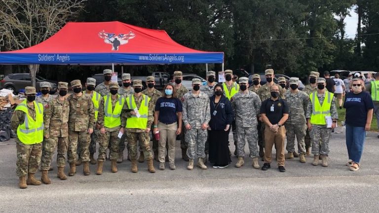 this photo shows volunteers from The Citadel as they provide food for low-income veterans as part of the Soldiers' Angels project.