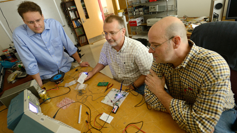 this photo shows University of Mississippi scientists who developed a prosthetic device to help people overcome their stutters