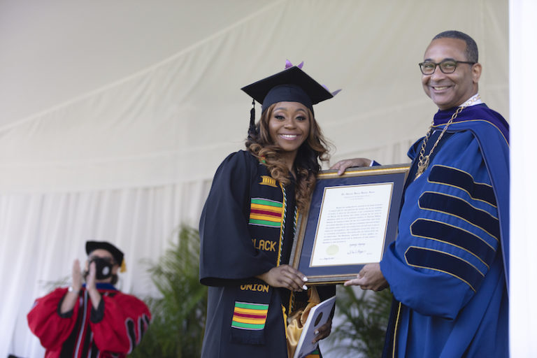 this photo shows Sydney Stepney accepting the Algernon Sydney Sullivan Award during a ceremony at Queens University of Charlotte.