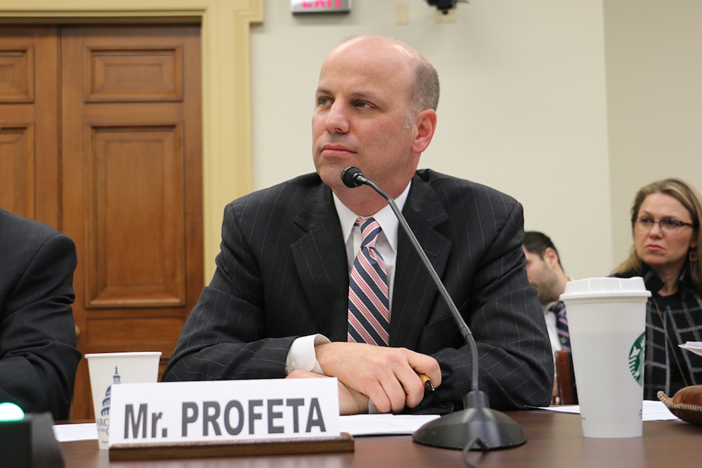 this photo shows Tim Profeta speaking to Congress about reducing carbon emissions in the U.S.