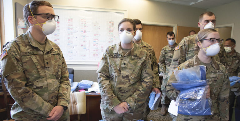 this photo shows Lincoln Memorial University veterinary medicine student Victoria Orlando in her National Guard uniform wearing a protective mask at a nursing facility
