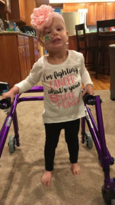 this is the photo of little Teagan Fettig, a six-year-old cancer survivor, using her walker to get around