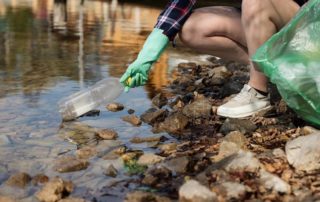 this photo shows a plastic bottle being retrieved from a river in California