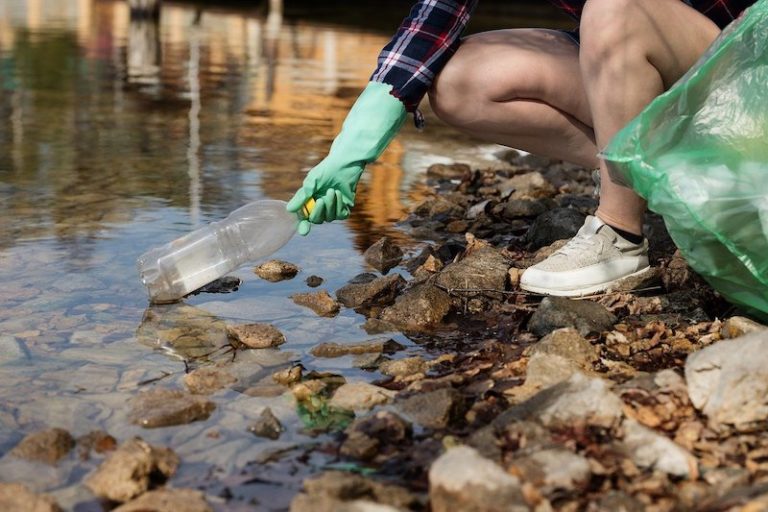 this photo shows a plastic bottle being retrieved from a river in California
