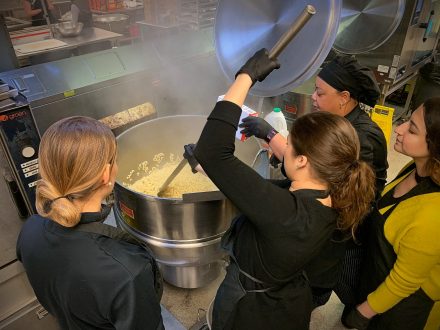 this photo shows Elon staff making food for Elon University's Turkeypalooza