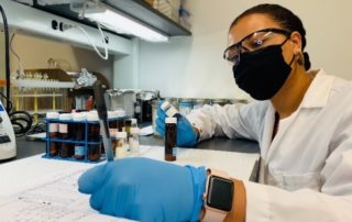 this photo shows Imari Walker Karega conducting research on microplastics in a laboratory at Duke University