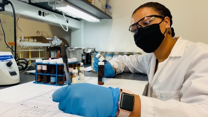 this photo shows Imari Walker Karega conducting research on microplastics in a laboratory at Duke University