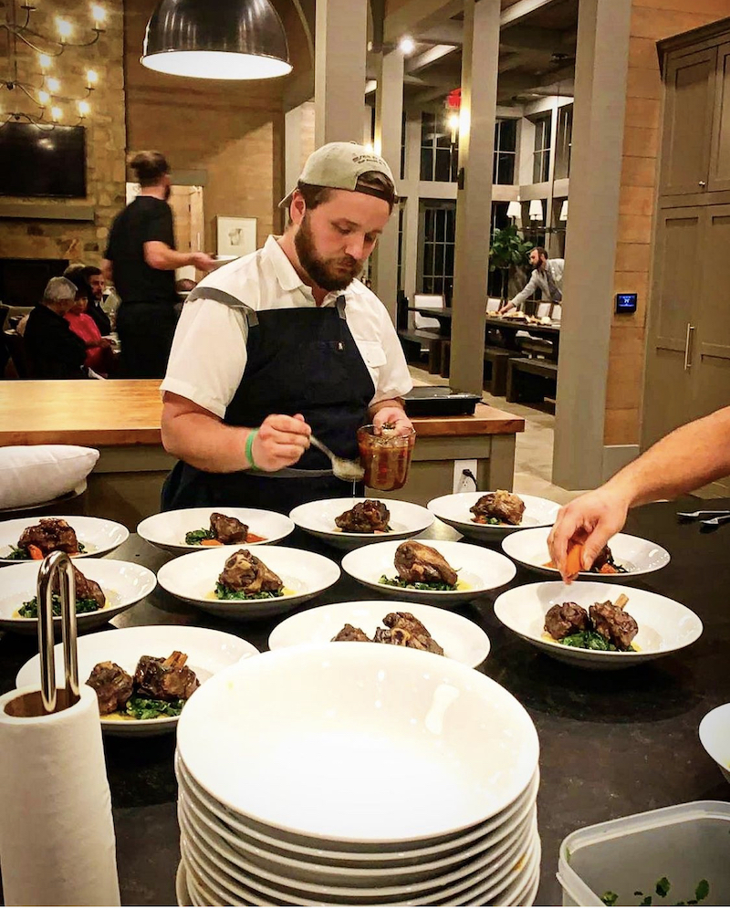 this is a photo of Jonathan Harrison of Next Level Chef making a meal for some Birmingham realtors at the Blackridge Club in Hoover, Alabama