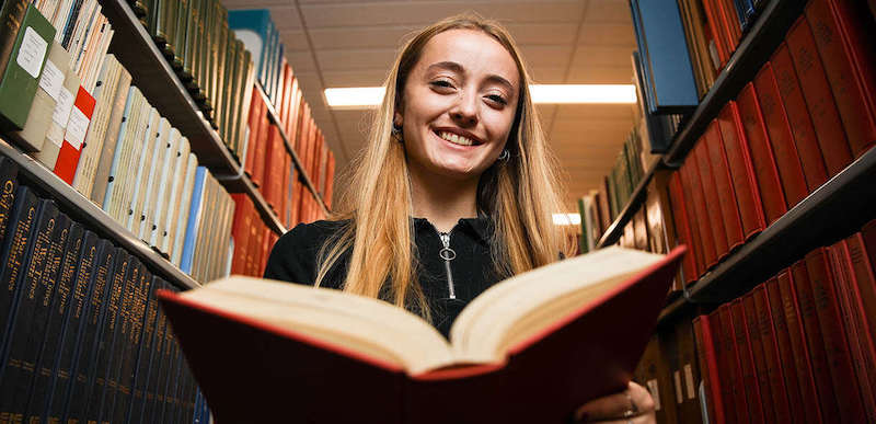 this photo shows Sullivan Scholarship recipient Beatrice Adams at the library of Lees-McRae College