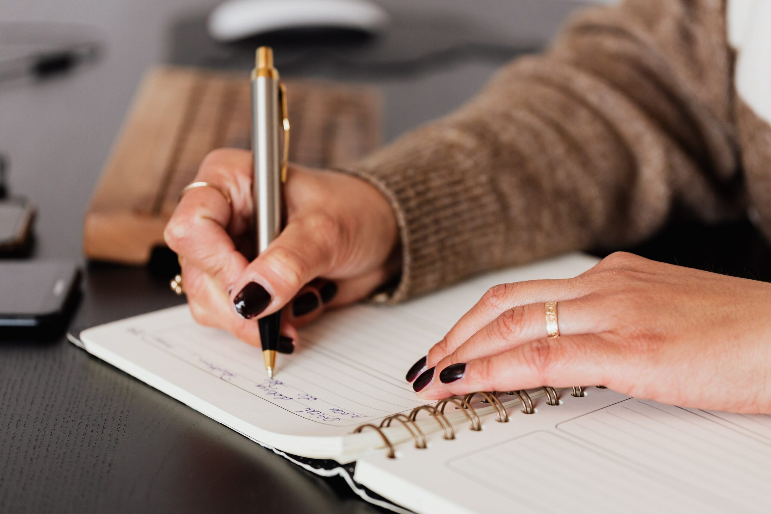 woman writing in a gratitude journal